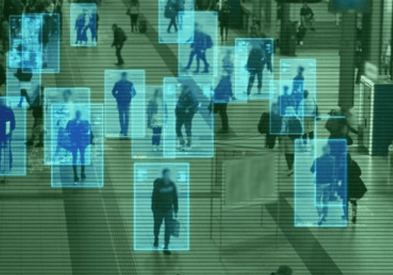 Surveillance footage with individuals marked by AI tracking in a public space.